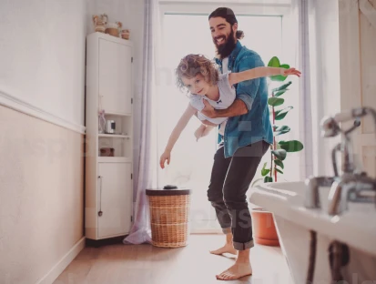 A father playing with his daughter making her fly.